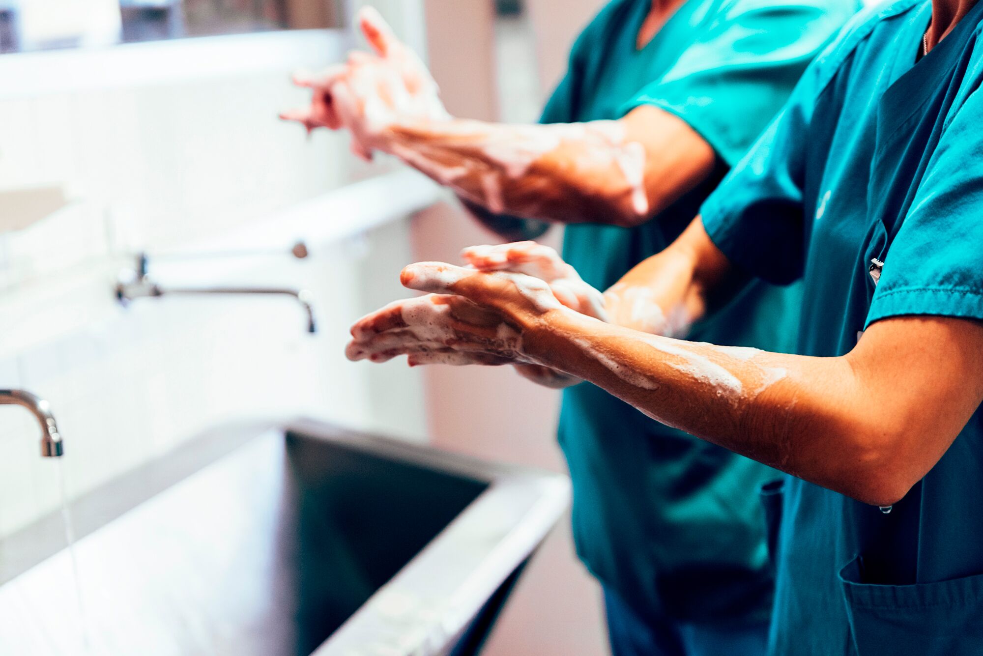 Couple of Surgeons Washing Hands Before Operating.