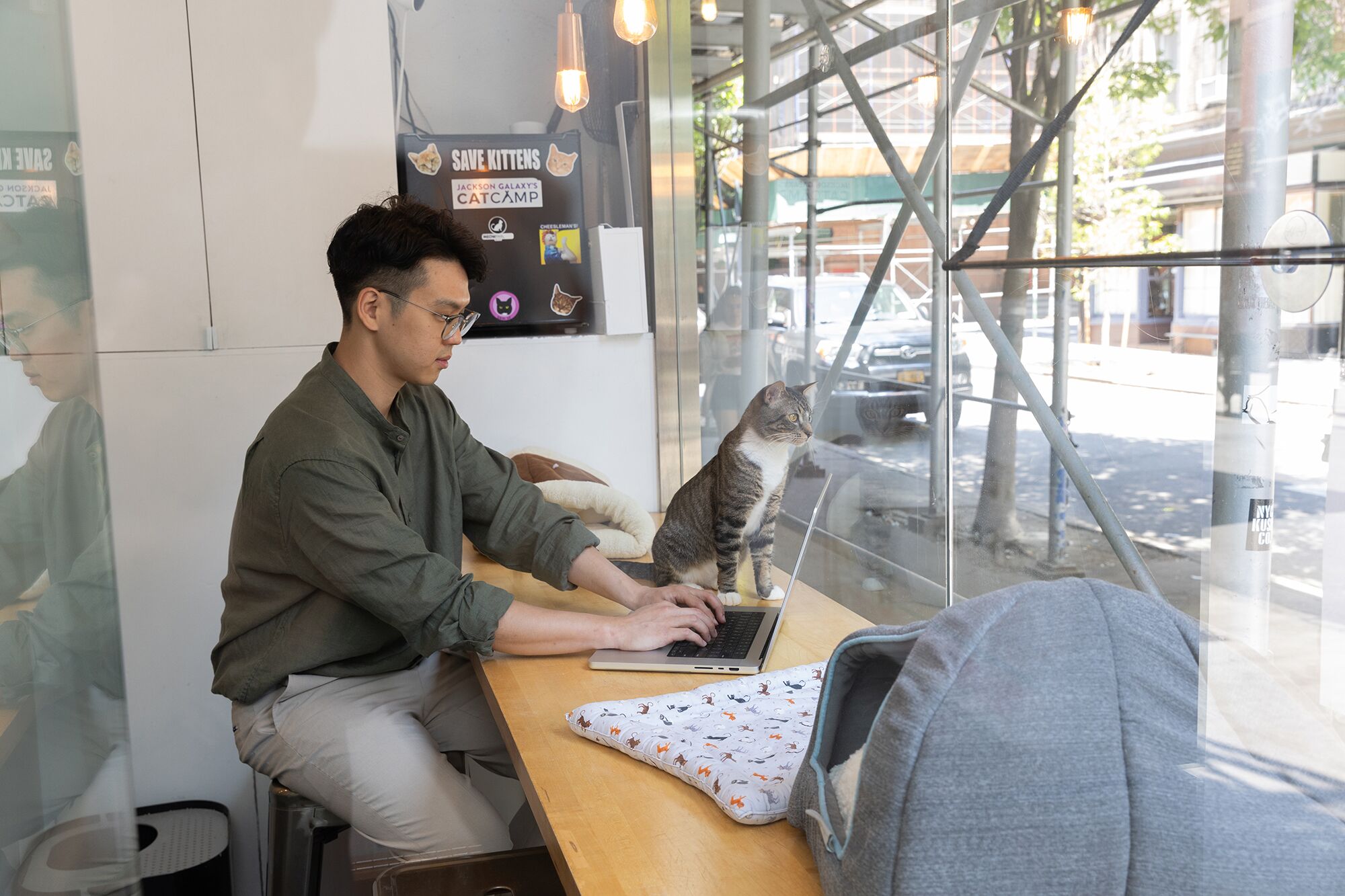 MetroPlusHealth representative speaking with a member at a customer service desk in NYC.